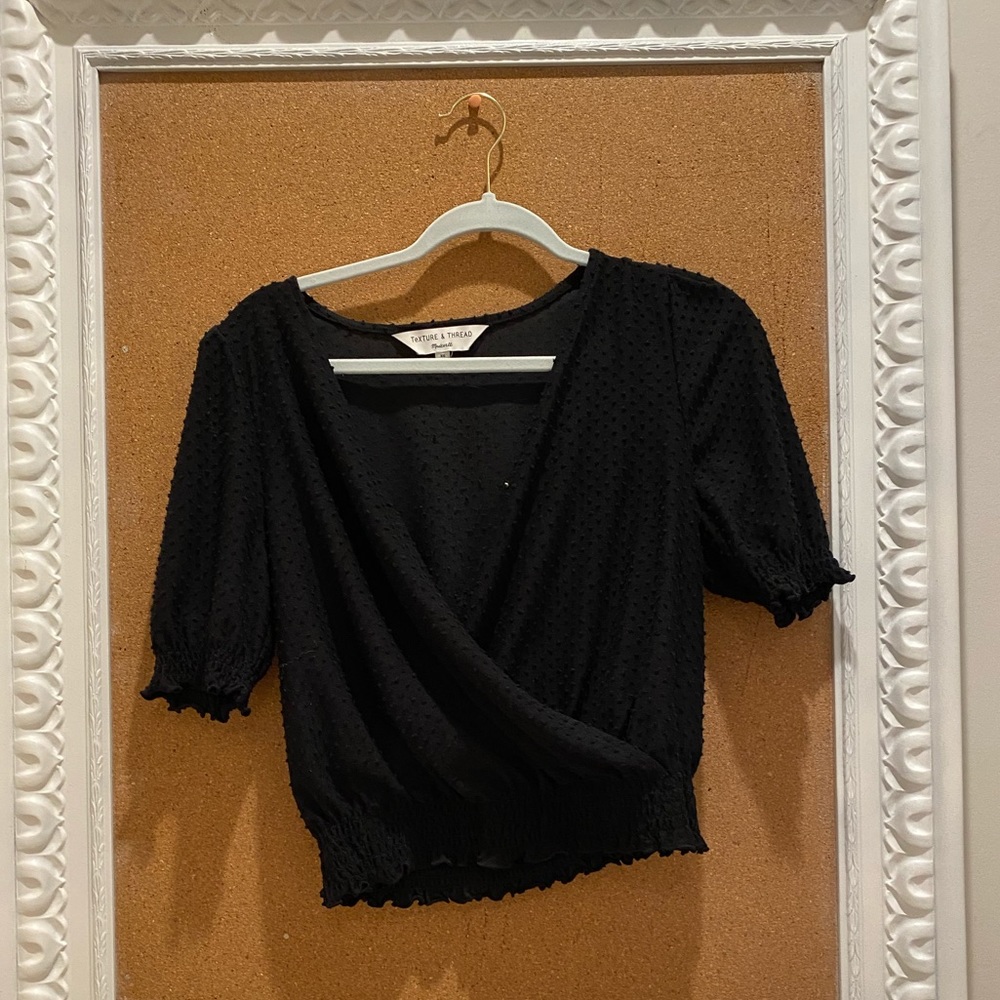 Women’s black, textured, blouse.